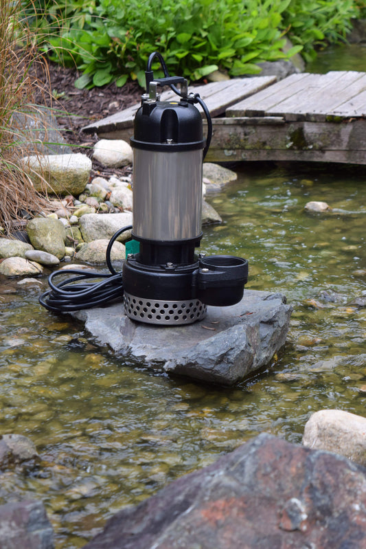 EasyPro TM13500 pump on rock with pond stream and wooden bridge in background