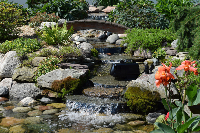 EasyPro EP1050 mag drive pump in garden stream with waterfalls and plants in background