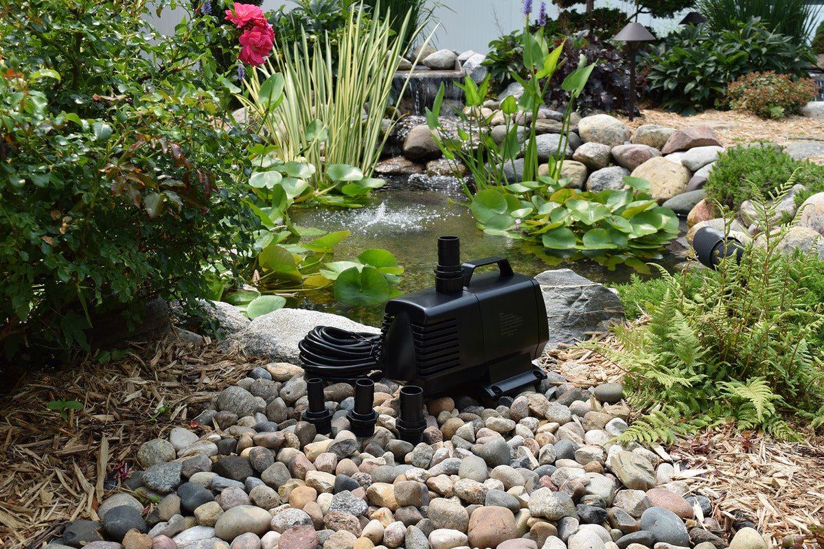 EasyPro EP2200 mag drive pump with nozzles beside garden pond and waterfall in background